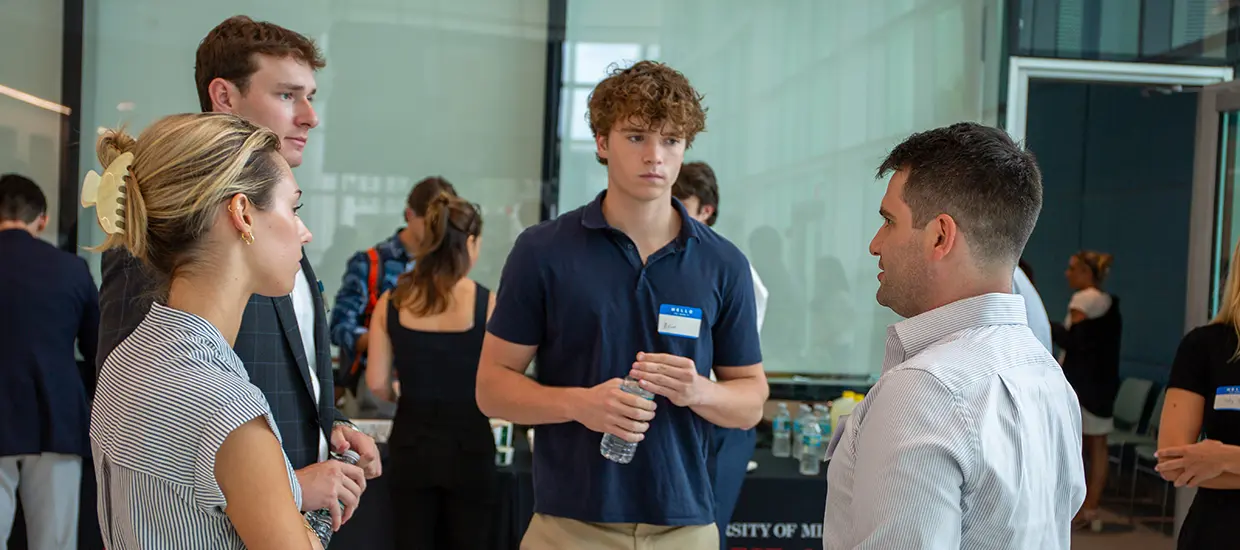 University of Miami students having a discussion at an event