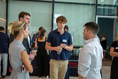 University of Miami students having a discussion at an event