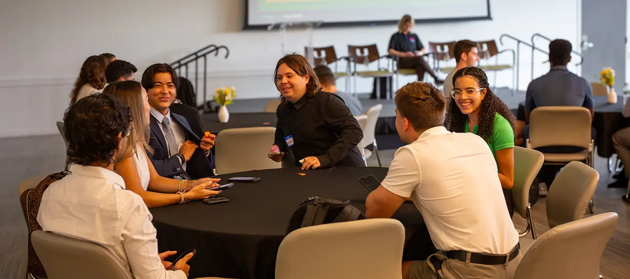 University of Miami students having a discussion at an event