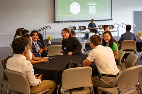 University of Miami students having a discussion at an event